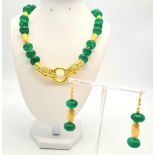 A Chinese necklace and earrings set with large emerald cabochons and gold plated dragons, in a