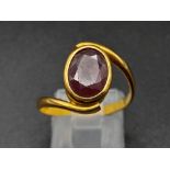 A 22K Yellow Gold Red Stone Crossover Ring. Size Q. 4.87g total weight. A/F. Ref - 8667.