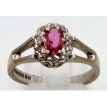 A Vintage 18K White Gold Natural Burmese Ruby and Diamond Ring. Central ruby surrounded with a