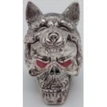 Unusual novelty silver white metal vesta case in the form of a skull and wolf with ruby coloured