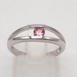 An 18K White Gold 0.20ct Torsion Set Pink Tourmaline Ring. Elegant and very modern, this solitaire