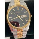 Gentlemans PULSAR QUARTZ wristwatch, DAY/DATE model,with black face, having golden digits and