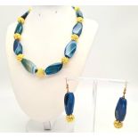 A fantastic, blue coloured, banded and large beaded agate, with gold plated (18 K) fittings,