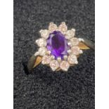 9 carat yellow GOLD RING having Amethyst centre with clear zirconia surround. 2.1 grams. Size M.