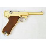 A golden LUGER semi-automatic gas powered pistol. This is an exact replica of the real thing, firing