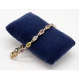 A 14K Yellow Gold Multi-Coloured Gemstone Bracelet. Peridot, amethyst, garnet, citrine and topaz.