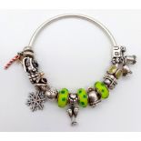 A Pandora Solid Silver Charm Bracelet - 16 charms. Including: Bells, church, cocktail glass, parcel,