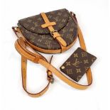 A Louis Vuitton Saddle Crossbody Bag. Monogrammed brown canvas and leather exterior. Zipped interior