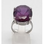 An 18K White Gold Amethyst Ring. Large central clean amethyst - 20ct. Size M. 10g total weight.