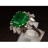 A GIA Certified 18K White Gold Emerald and Diamond Ring. 4.35ct central octagonal-cut emerald