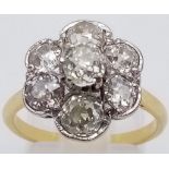 An 18K Yellow Gold Diamond Floral Cluster Ring. Quality centre stone surrounded by six quality