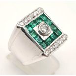 A Heavy 18k White Gold Emerald and Diamond Dress Ring. Central round-cut brilliant diamonds
