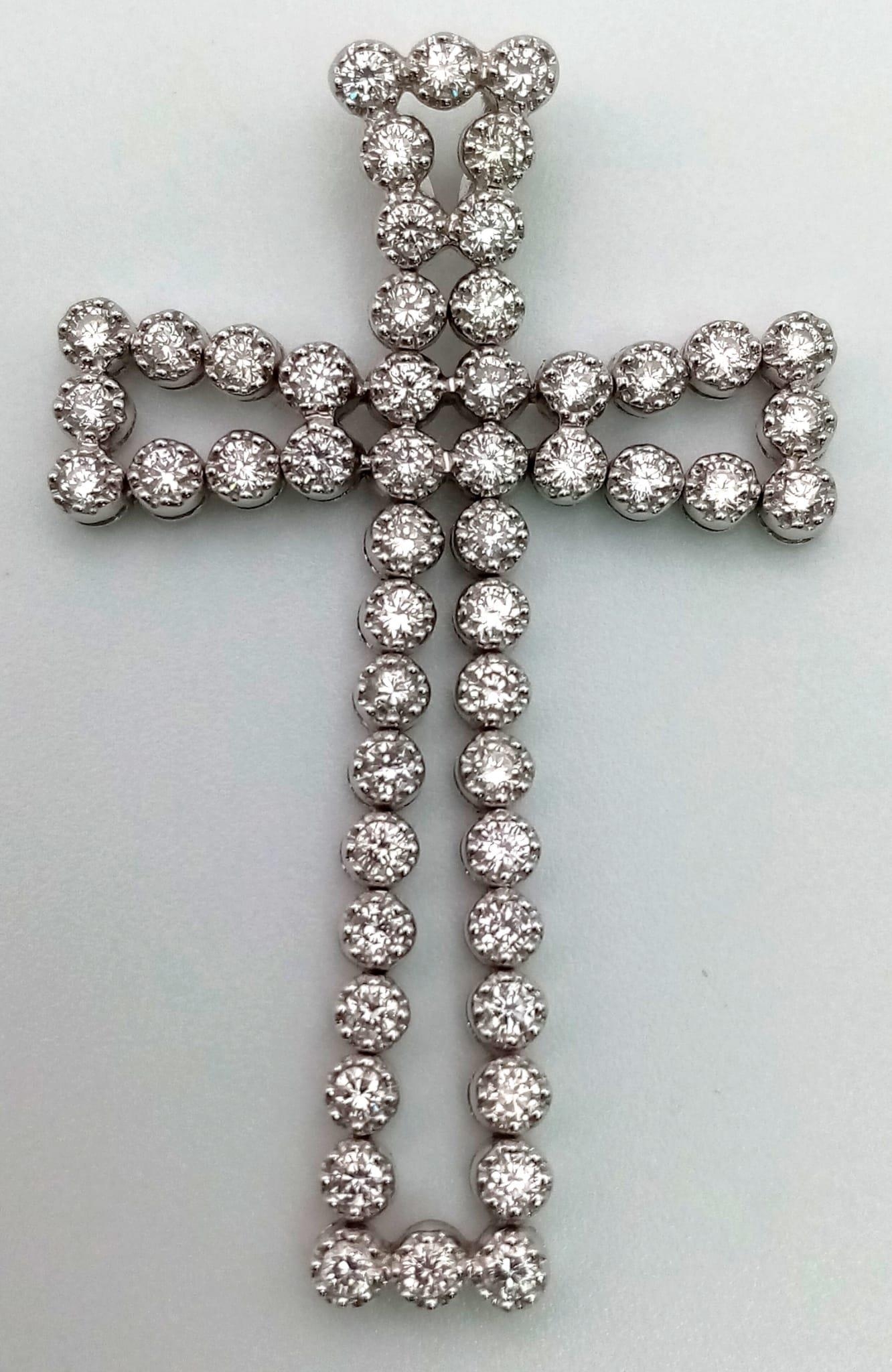 An 18K White Gold Diamond Cross Pendant. 5ct of exceptional bright round-cut diamonds create a