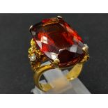 An 18K Yellow Gold Amber Citrine and Diamond Ring. A large cushion mixed-cut natural citrine and two