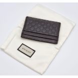 A Gucci Leather Monogrammed Wallet. 10 x 7cm. Very good condition but please see photos. Comes in