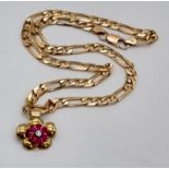 A 9K Yellow Gold Figaro Link Chain with a 9K Yellow Gold Floral Pendant with Pink Sapphire and
