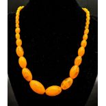 A Vintage Honey-Amber Graduated Bead Necklace. 20mm largest bead. 46cm. 51.35g total weight.