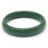A Tibetan, Buddhist, green jade bangle, with mantras engraved on the surface of the bangle. Internal