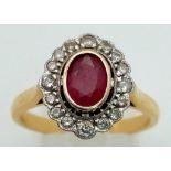 An 18 K yellow gold ring with an oval cut ruby surrounded by diamonds. Ring size: R, weight: 5.4 g.