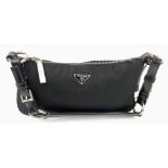 Prada Nylon and Black Leather Baguette Bag. Silver-toned hardware. Monogrammed cloth interior with
