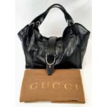 A Black Leather Gucci Handbag. Silver toned hardware. Monogrammed inner with zip pocket. 32 x