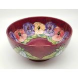 A Large Burgundy Base Glazed Moorcroft Floral Decorated Bowl. 20cm diameter. Markings on base.