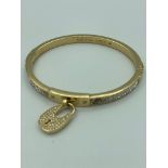 MICHAEL KORS jewelled BANGLE in gold tone with jewelled padlock, complete with Michael Kors soft