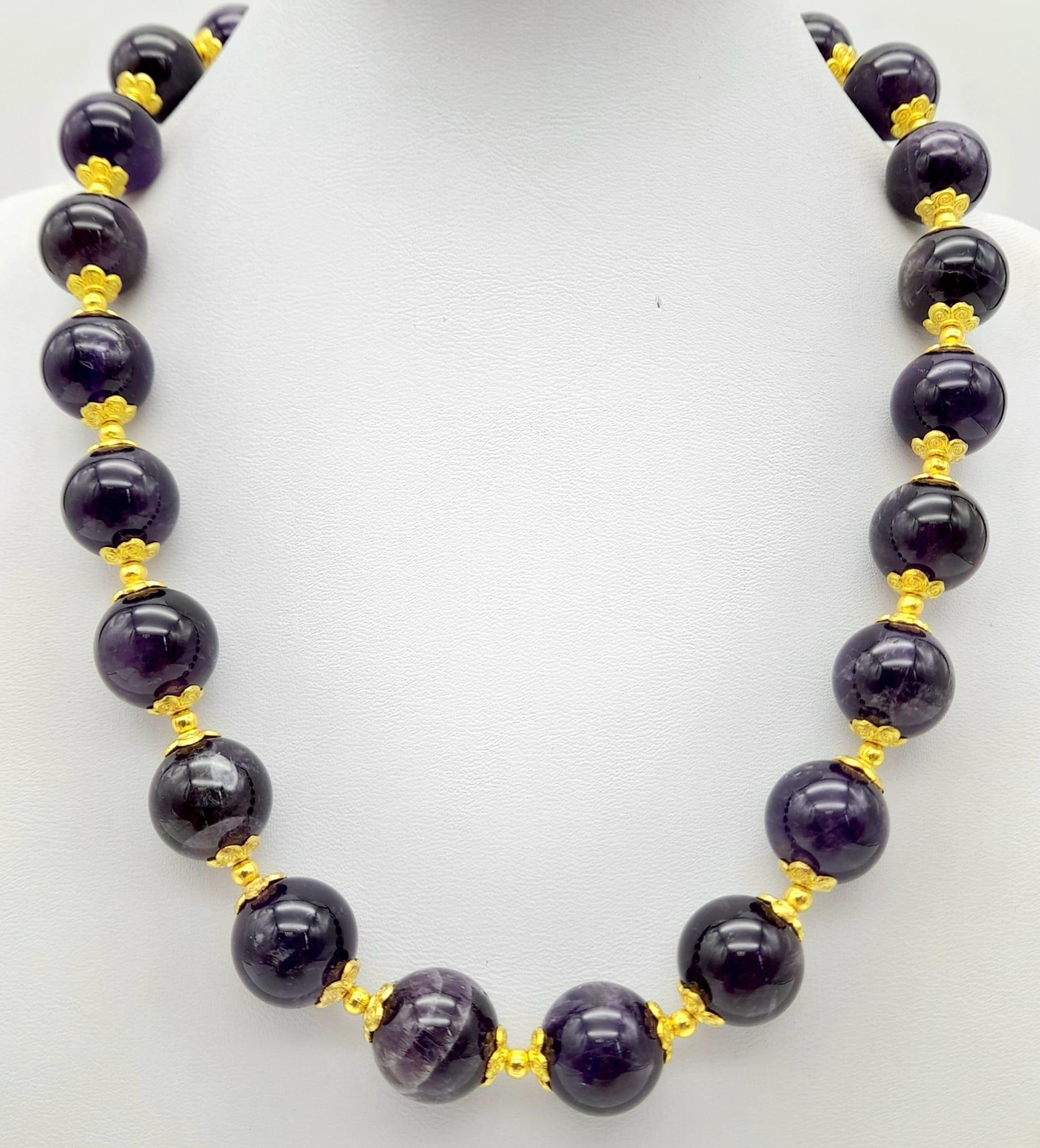 A Purple Stone, Possibly Amethyst Beaded Necklace. Gilded spacers and clasp. 42cm