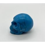 A Turquoise Coloured Hand-Carved Crystal Skull Figure. 5 x 4.5cm
