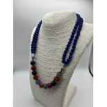 A Stylish Multi-Coloured Onyx Bead Necklace. A row of double strand blue onyx beads give way to a