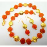 A very unusual, hand carved, rose forming, carnelian beads and yellow gold gilded necklace and