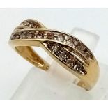 A 9 K yellow gold ring with two bands of diamonds (0.25 carats) in a twist design.
