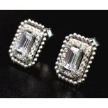 A 14 K white gold, stone set pair of stud earrings. Weight: 2.8 g.
