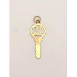 9k yellow gold 21 key charm/pendant, 25mm in length, 0.4 grams total weight