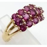 A 9K Yellow Gold Three-Row Ruby Ring. Fifteen clean, quality rubies add a touch of class to this