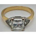 An 18K Yellow Gold Diamond Solitaire Ring. Excellent quality princess cut 2ct centre stone flanked