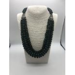 A Three-Row Shades of Green Bloodstone Rondelle Statement Necklace. Graduated beads with pierced