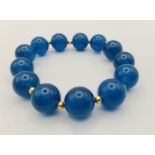 A Blue Apatite Bead Expandable Bracelet. Gilded spacers.