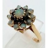A 9 K yellow gold ring with a cluster of opals and sapphires. Size: P, weight: 3.2 g.