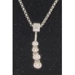 An 18K White Gold Floating Graduated Diamond Pendant on an 18K White Gold Chain. 0.40ct of natural