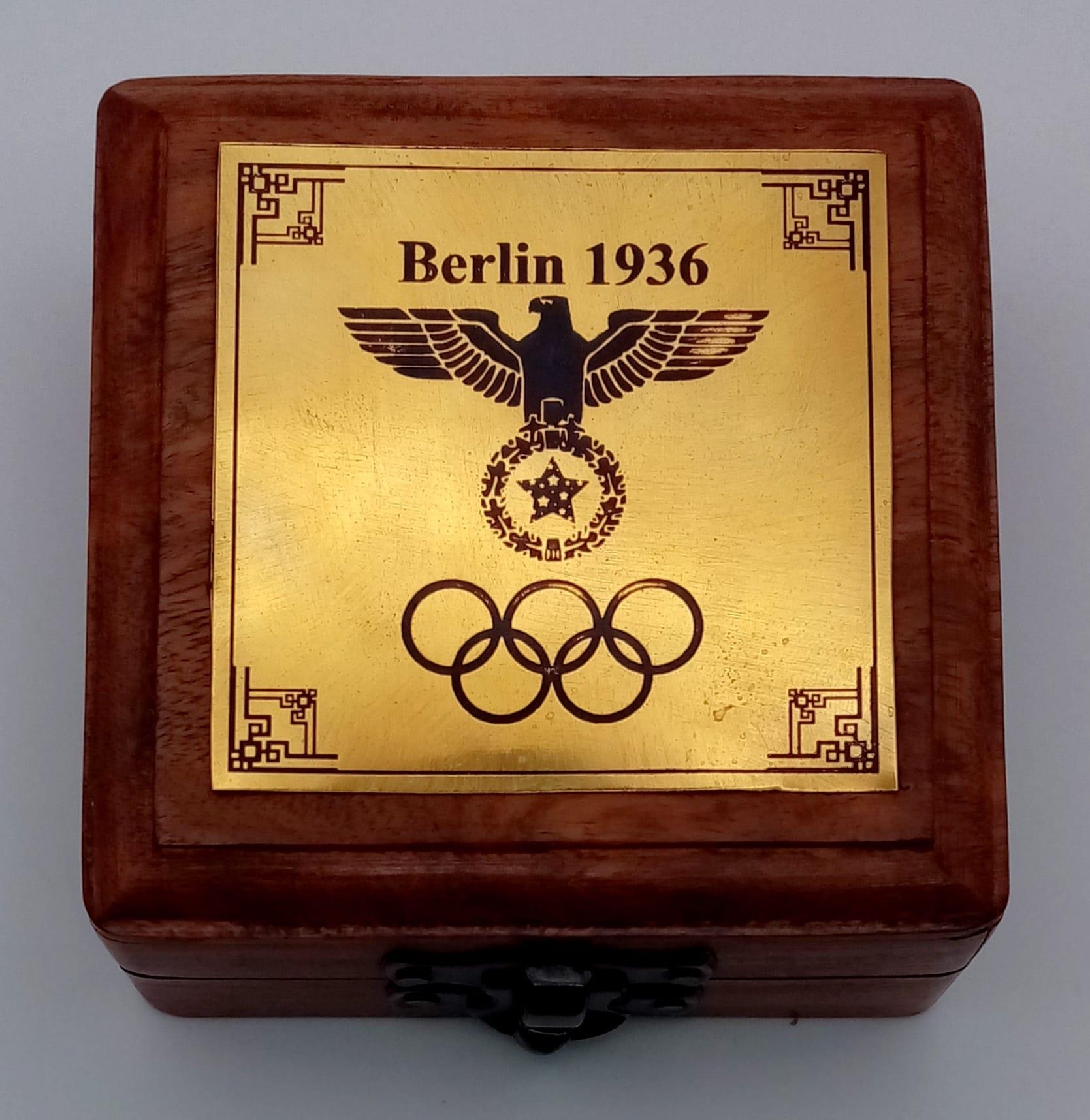 A brass compass with immobiliser, brass chain and inscription BERLIN 1936 in a wooden box with - Image 6 of 6