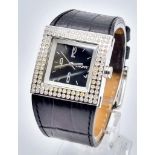 A DKNY Dress Watch. Leather strap. Stainless steel case - 30 x 30mm. White stone bezel. Quartz
