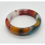 A Multi-Coloured Jade Bangle. 6cm inner diameter.