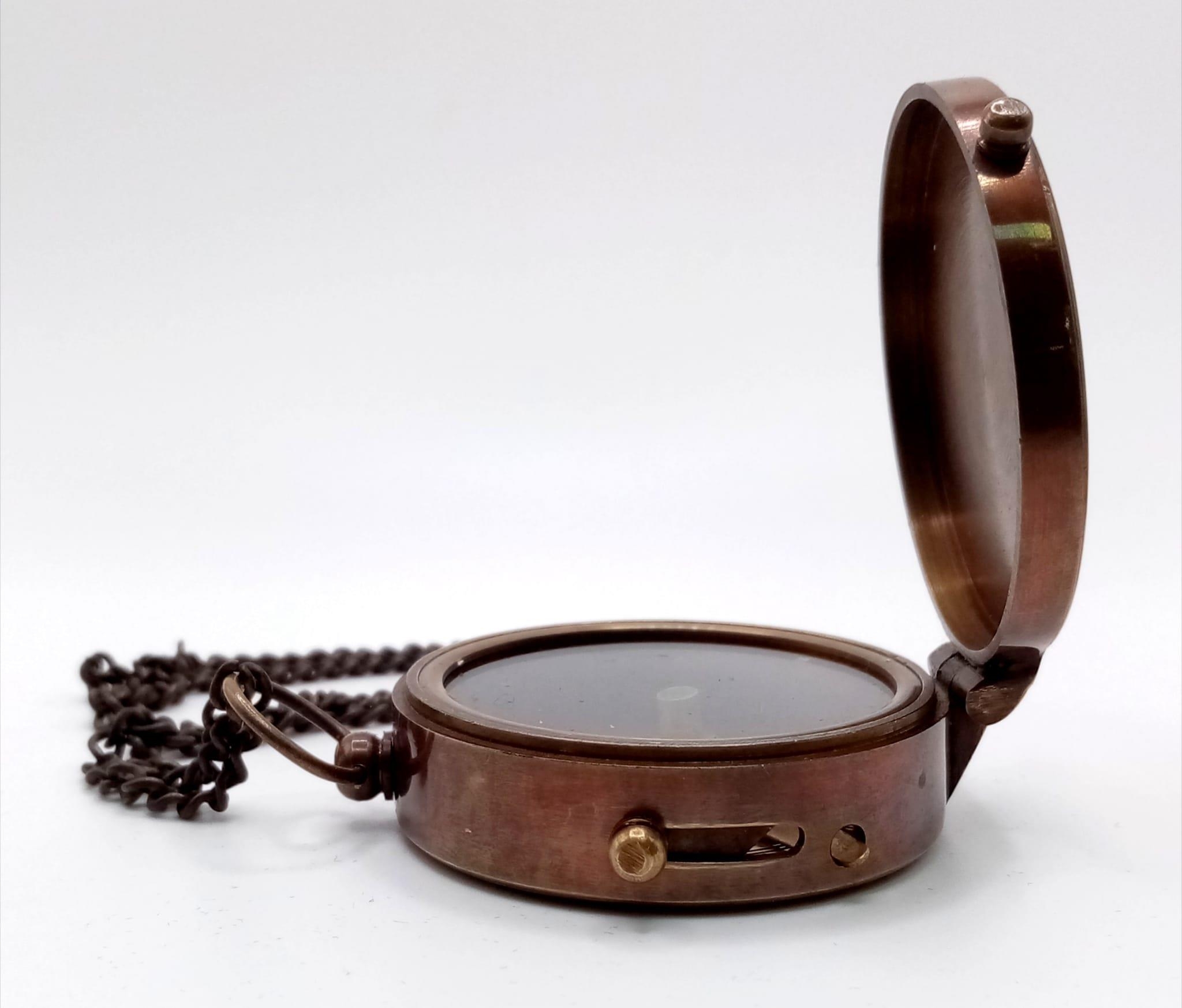 A brass compass with immobiliser, brass chain and inscription BERLIN 1936 in a wooden box with - Image 3 of 6