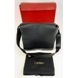 A Cartier Leather Shoulder Bag. Large flap front cover with zip pocket and open pocket interior.