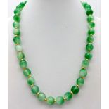 A Green Jade Bead Necklace. Gilded spacers and clasp. 42cm