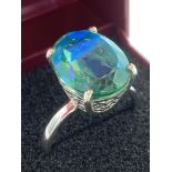 SILVER and TORQUOISE TOURMALINE RING having oval cut 3.5 carat stone set to top in cradle filigree