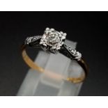 An Illusion set 0.33 carat diamond ring set with diamond shoulders. This is set in 18ct yellow