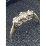 18 carat GOLD and DIAMOND RING having three DIAMONDS set to top in PLATINUM mount. 2.4 grams. Size