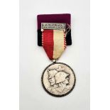 Two Vintage German Medals Comprising a Jubilaums Patrouillenlauf Medal and a Kriegshilfdienst Badge.
